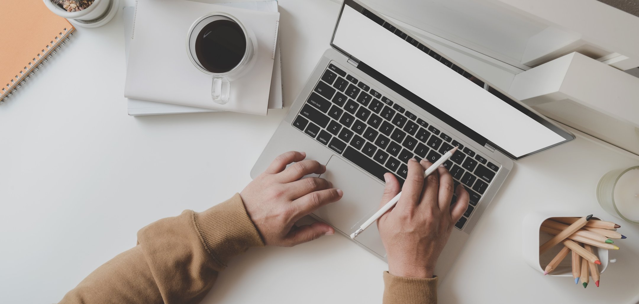 Working Man Is Typing on Black Frame Laptop